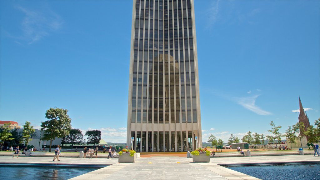 Corning Tower showing a pond and a high-rise building