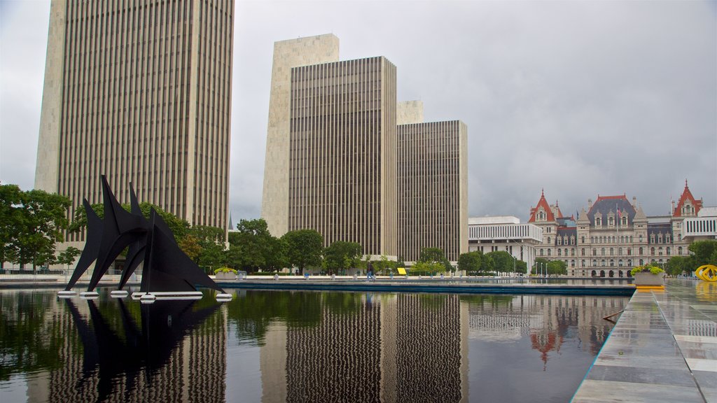 Governor Nelson A. Rockefeller Empire State Plaza which includes a pond, a city and outdoor art