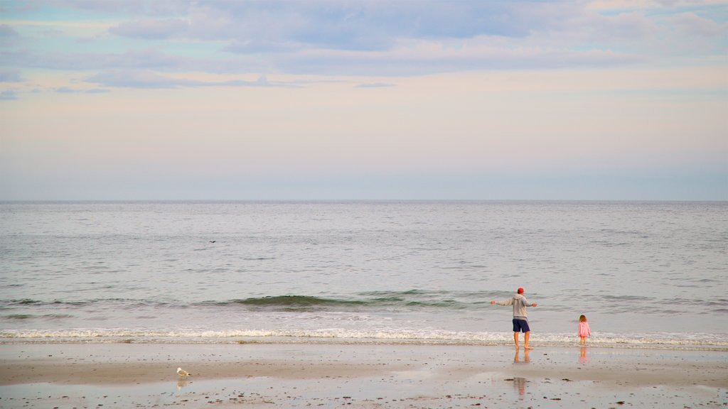 Mother\'s Beach showing a sandy beach and general coastal views as well as a family