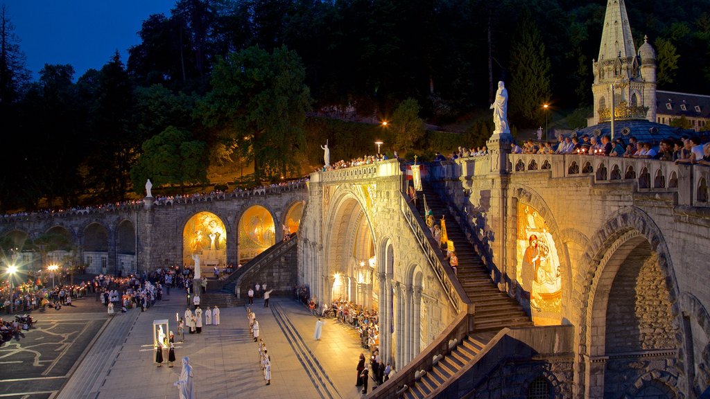 Rosary Basilica featuring heritage architecture and night scenes as well as a large group of people