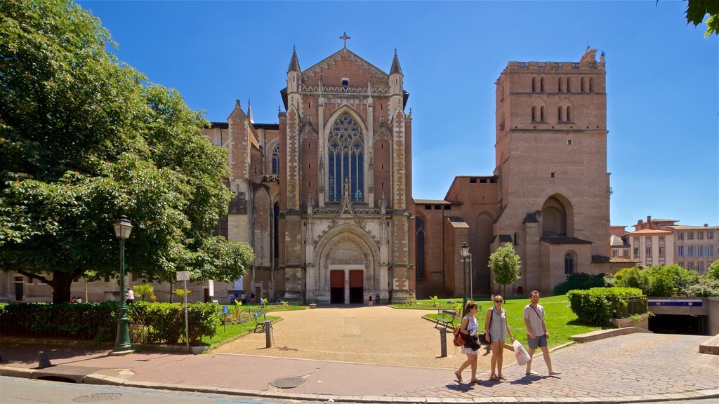 Saint Etienne Cathedrale showing heritage architecture and a church or cathedral as well as a small group of people