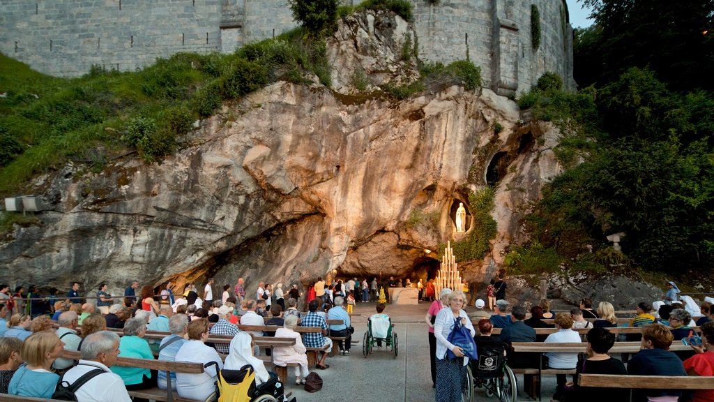 Gruta de Massabielle mostrando elementos religiosos y también un gran grupo de personas