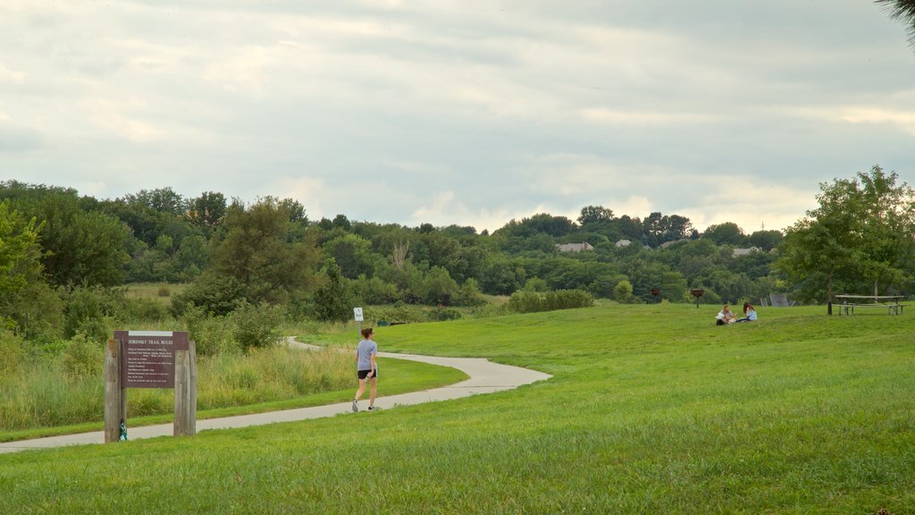 Zorinsky Lake Park showing a park and hiking or walking as well as an individual femail