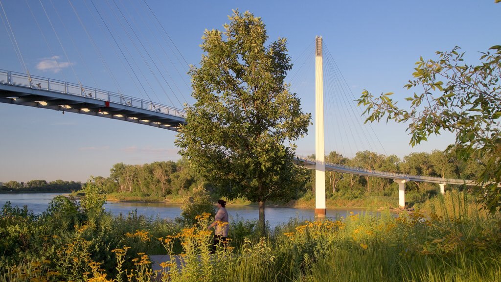 Bob Kerrey Pedestrian Bridge featuring a river or creek and a bridge