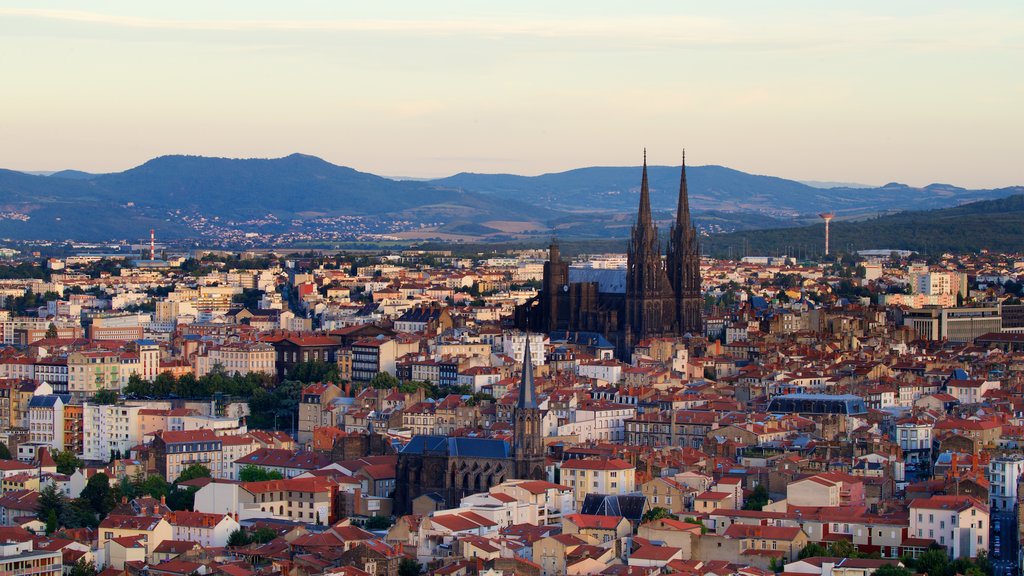 Montjuzet Park featuring a church or cathedral, a sunset and heritage architecture