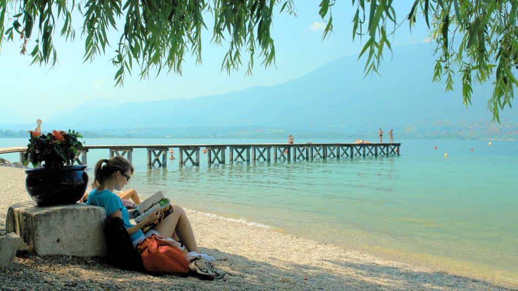 Aix-les-Bains showing a sandy beach and landscape views as well as an individual femail