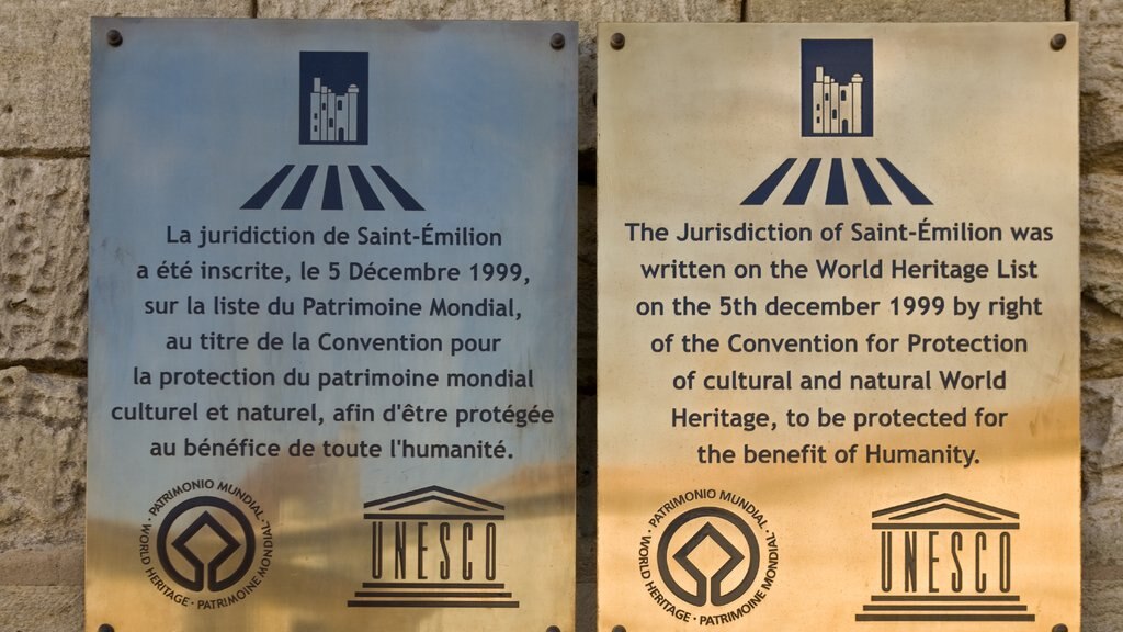 Saint-Emilion featuring a memorial, signage and heritage architecture