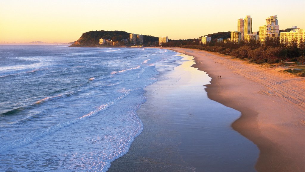 Burleigh Beach which includes a coastal town, a beach and a sunset