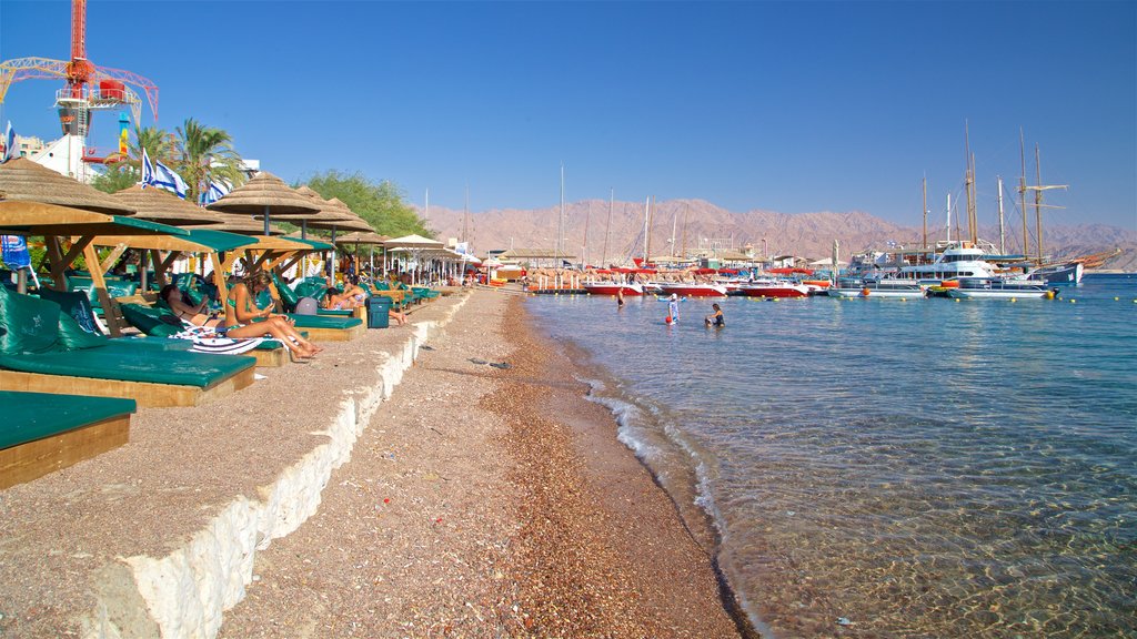 Green Beach showing swimming, a pebble beach and general coastal views