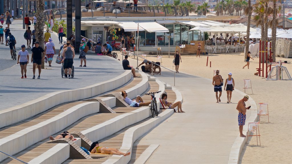 Lahat Promenade showing general coastal views and a sandy beach as well as a small group of people