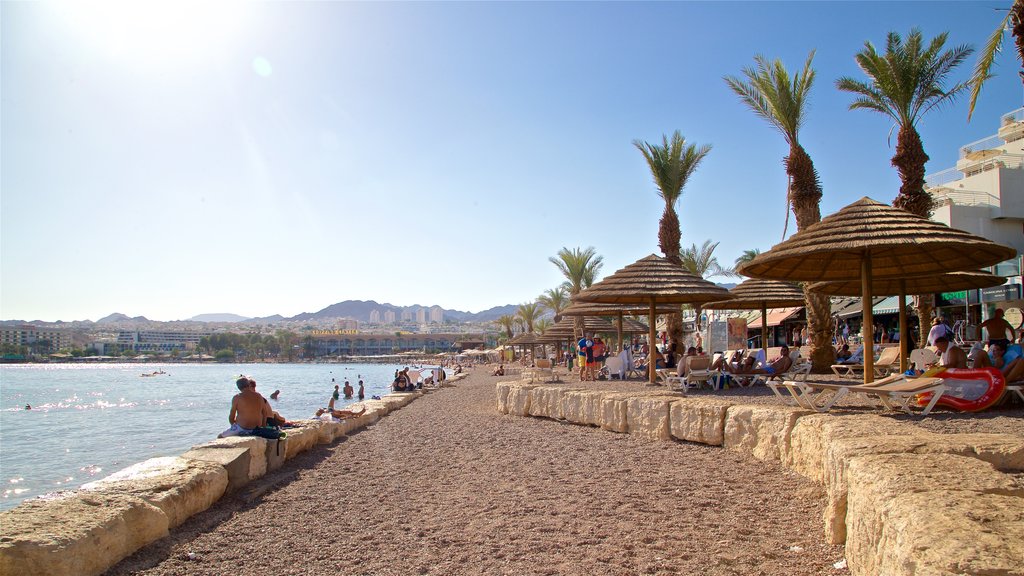 Playa Verde ofreciendo una playa y vistas generales de la costa y también un pequeño grupo de personas