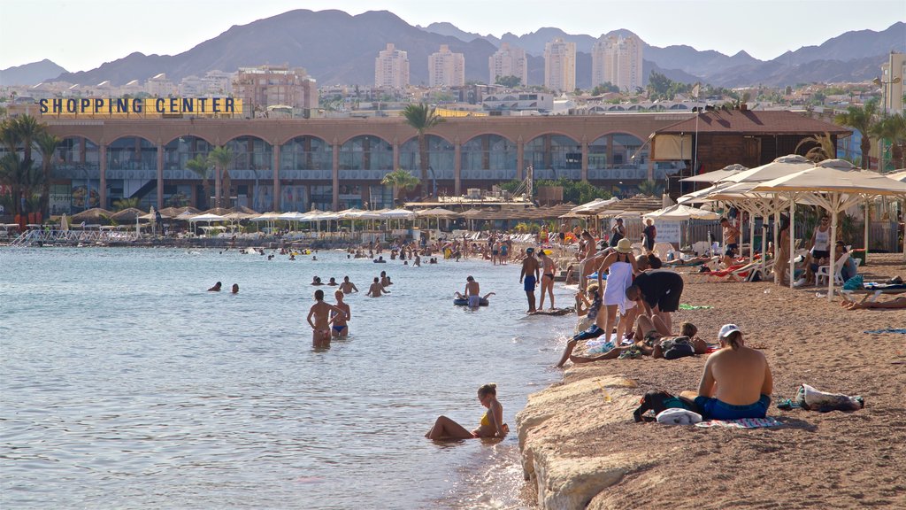 Green Beach which includes a sandy beach, general coastal views and a coastal town