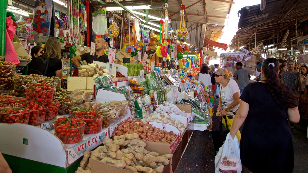 Carmel Market which includes markets and food as well as a small group of people