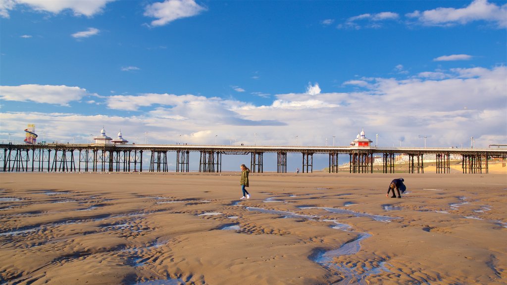 Blackpool Beach which includes a beach and general coastal views as well as a couple