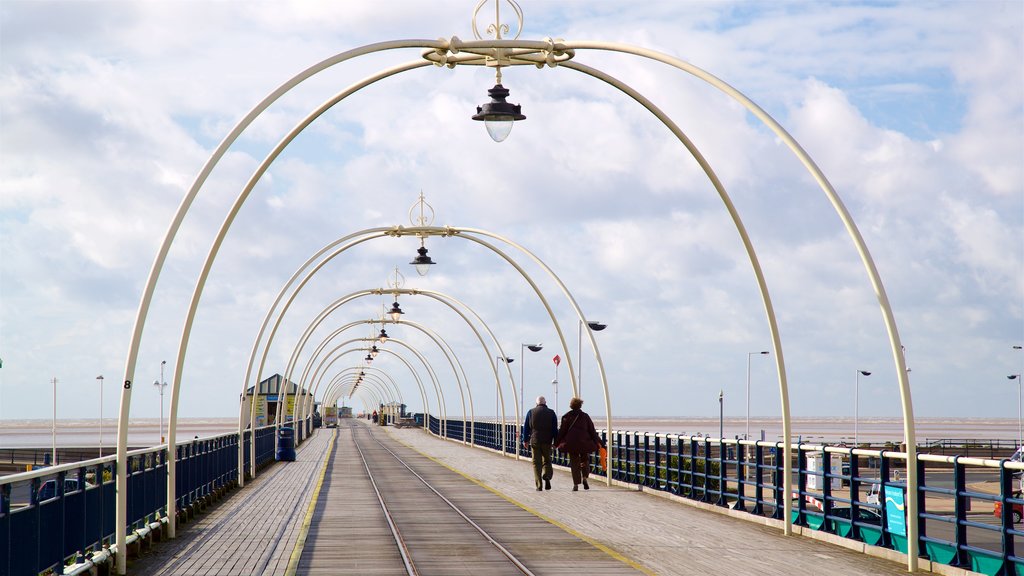 Southport Pier que incluye vistas generales de la costa y también una pareja