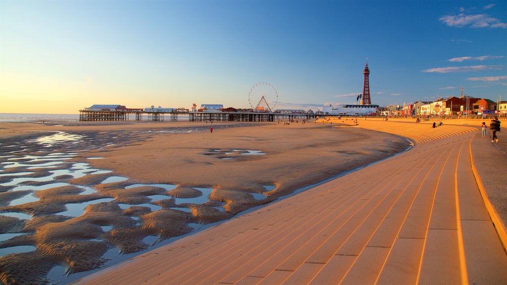 Blackpool Central Pier which includes a sunset, a beach and general coastal views