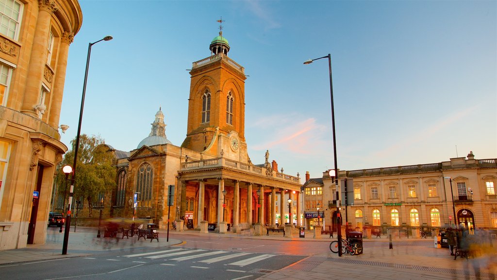 All Saints Church which includes a city, a sunset and heritage architecture