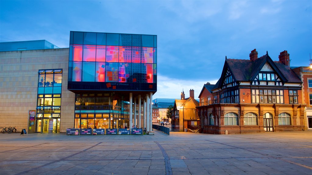 Quad which includes a square or plaza, modern architecture and night scenes