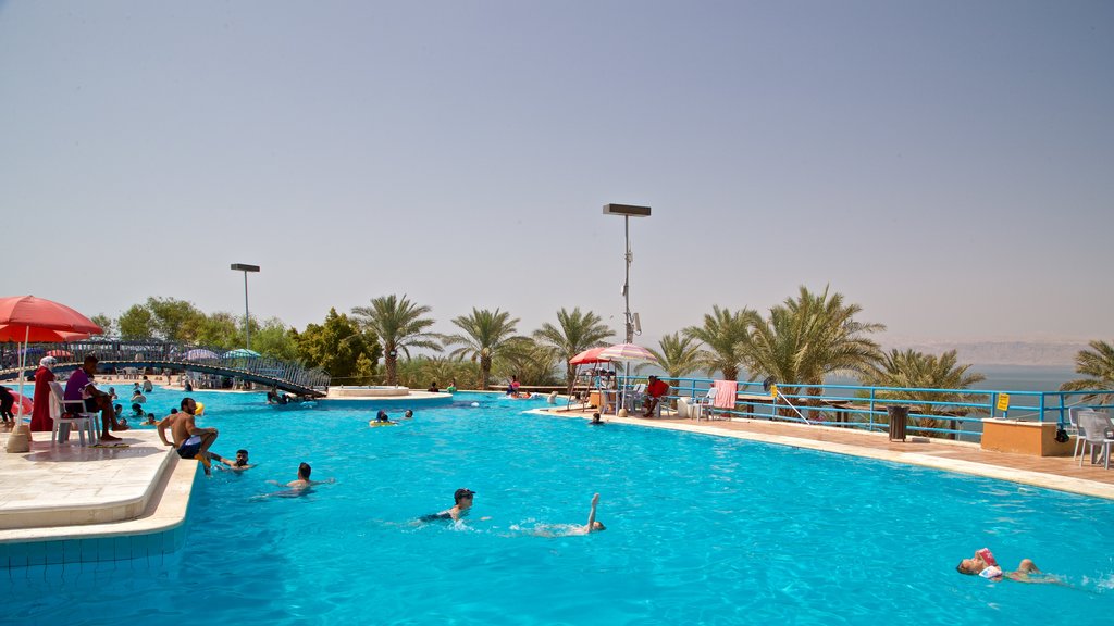 Praia de Amã que inclui paisagens litorâneas, uma piscina e natação