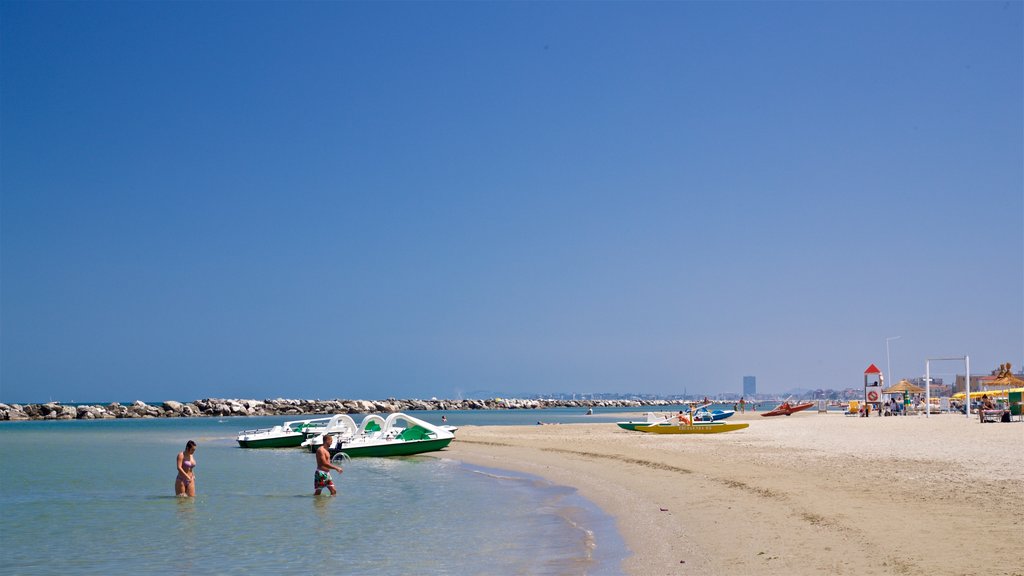 Torre Pedrera showing general coastal views, swimming and a beach