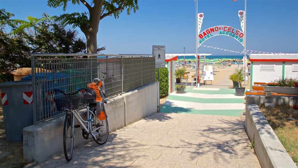 Torre Pedrera which includes signage and general coastal views