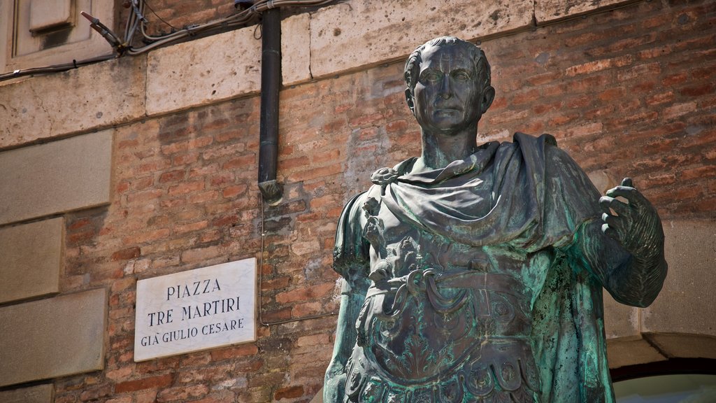 Piazza Tre Martiri featuring a statue or sculpture and signage