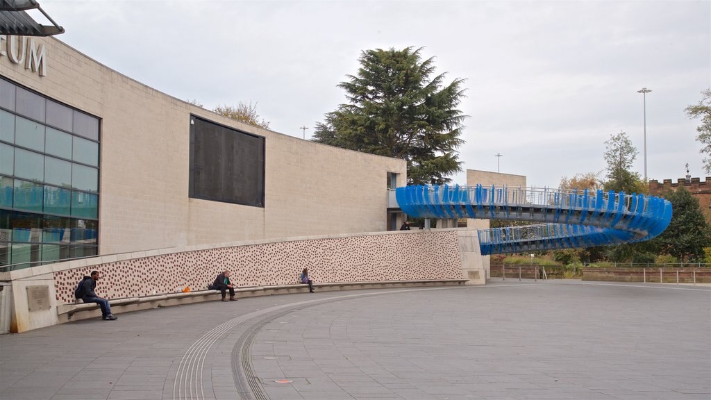 Coventry Transport Museum featuring a square or plaza as well as a small group of people