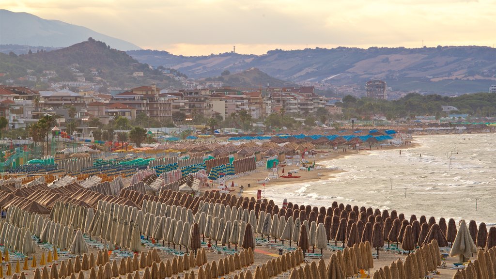 Pescara which includes a coastal town, a beach and a sunset