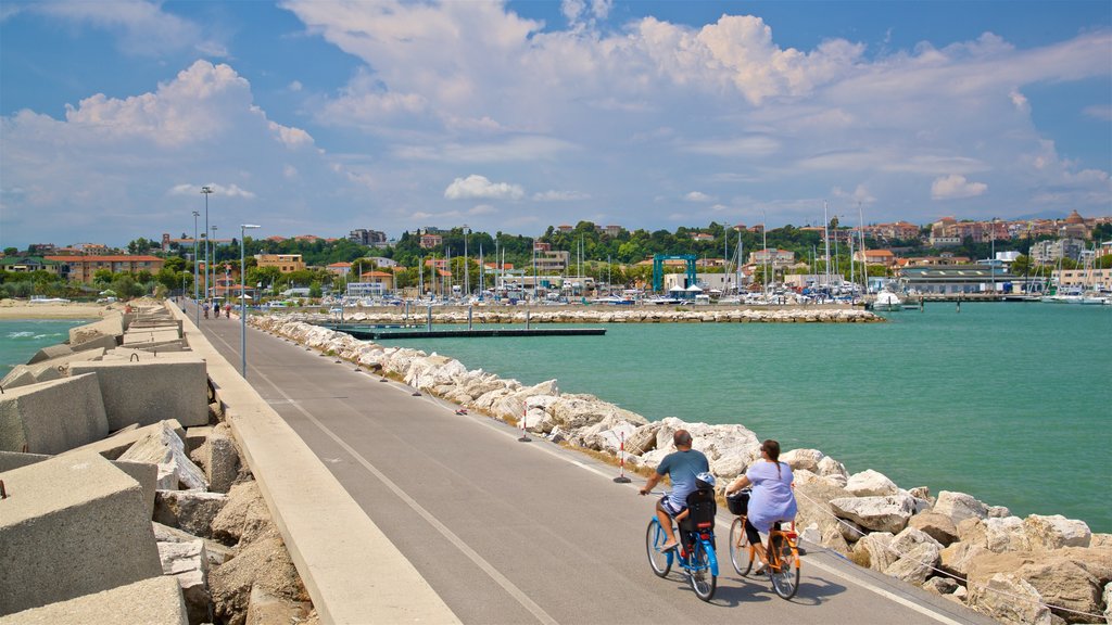 Giulianova Harbor showing a bay or harbour and cycling as well as a couple