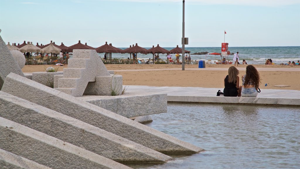 Pescara which includes a fountain and a sandy beach as well as a couple