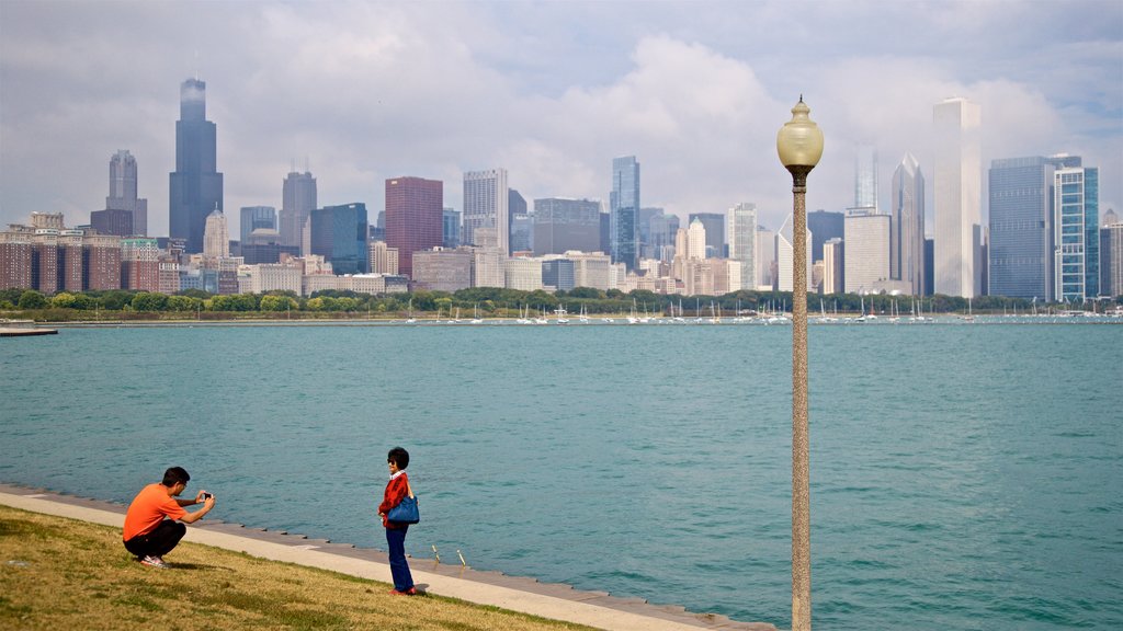 Northerly Island Park showing a city and a bay or harbour as well as a couple