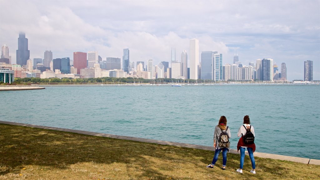 Northerly Island Park which includes a bay or harbour and a city as well as a couple