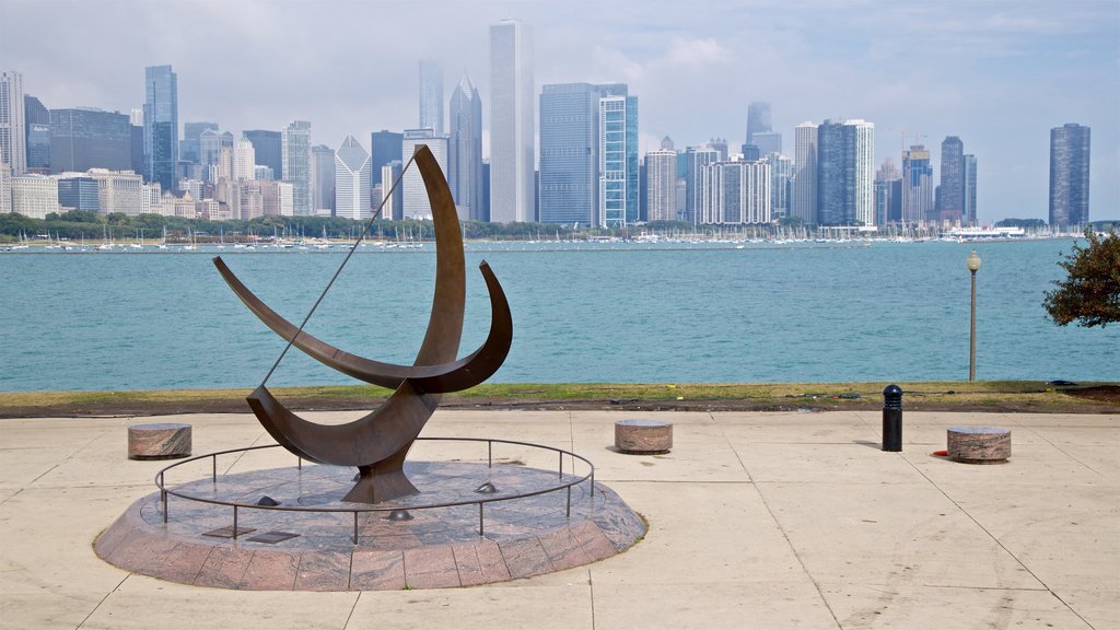 Sundial which includes a city, a river or creek and outdoor art