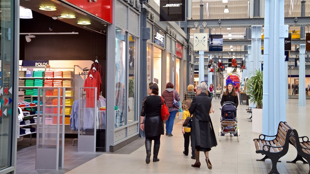 Swindon Designer Outlet showing interior views and shopping as well as a small group of people