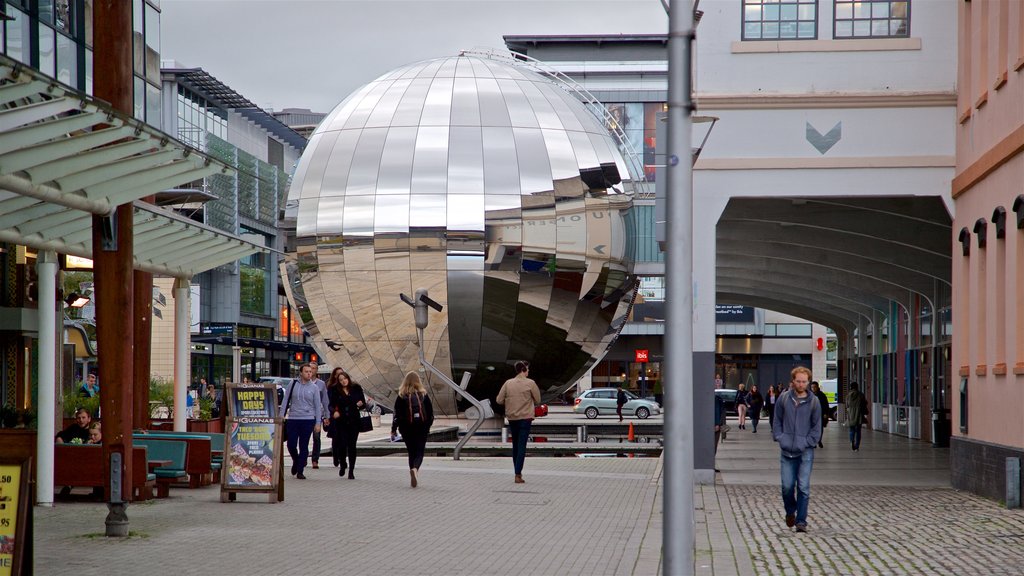 Millennium Square showing outdoor art and street scenes as well as a small group of people