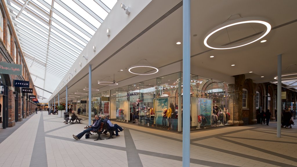 Swindon Designer Outlet featuring shopping and interior views as well as a small group of people