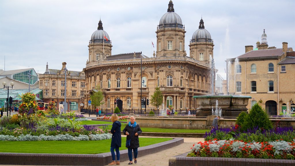 Queens Gardens featuring a fountain, heritage architecture and flowers