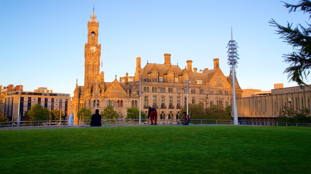 Bradford City Hall which includes a sunset, heritage architecture and a park