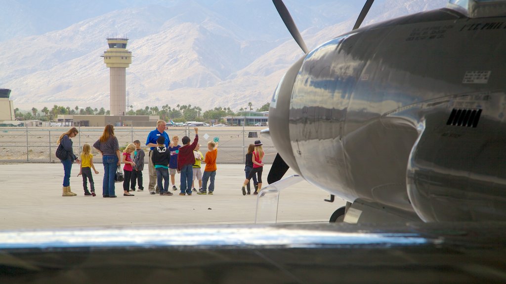 Palm Springs Air Museum showing aircraft as well as a large group of people