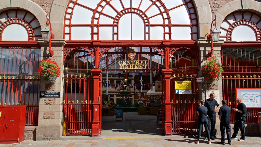 St. Helier Central Market featuring signage as well as a small group of people