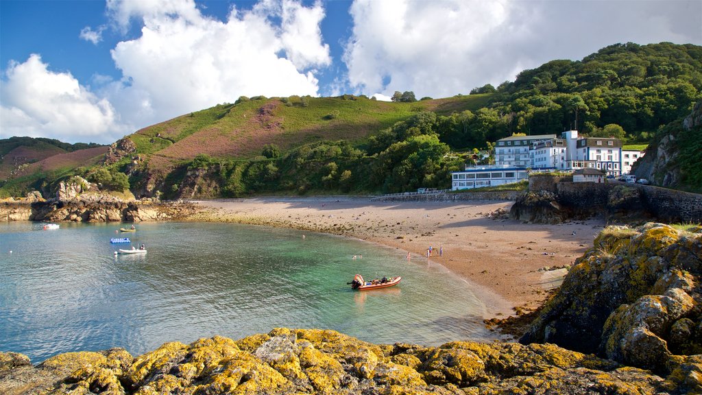 Bouley Bay which includes a house, general coastal views and rocky coastline