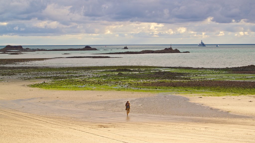 St. Helier Beach featuring a beach and general coastal views as well as an individual female