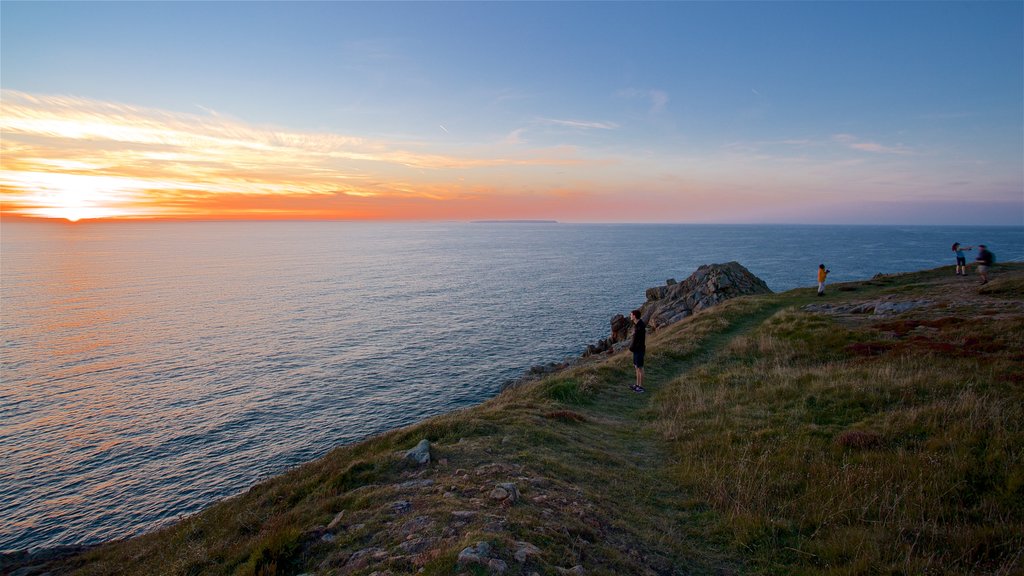 Grosnez Castle which includes general coastal views, a sunset and rugged coastline