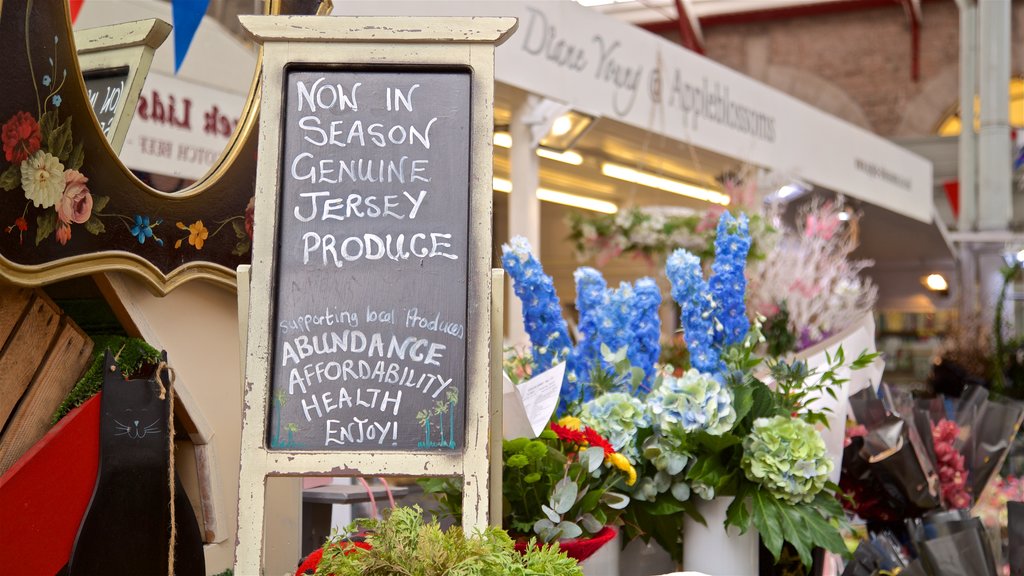 Mercado central de St. Helier que incluye flores, señalización y mercados