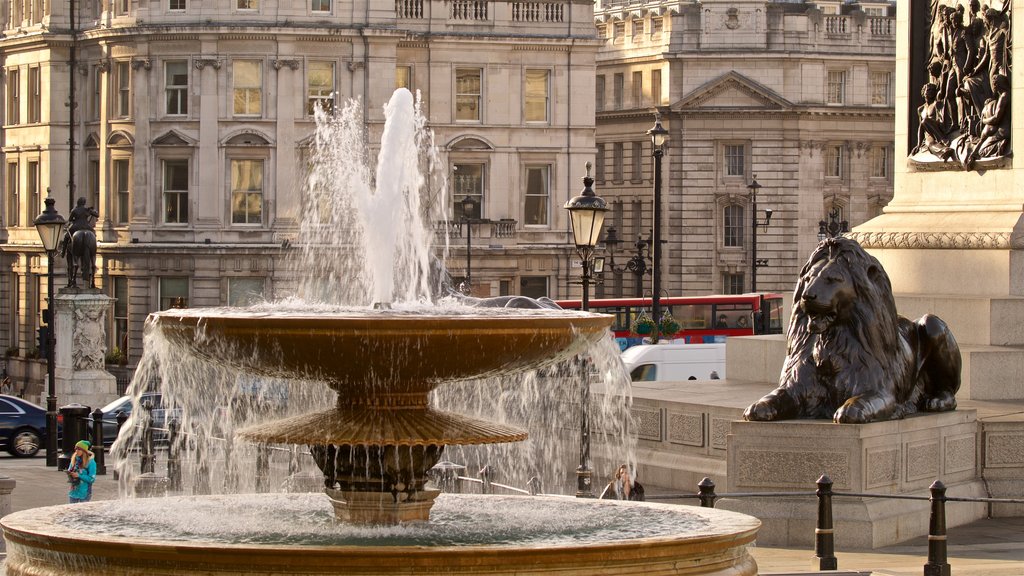 Trafalgar Square which includes a fountain, a statue or sculpture and a city