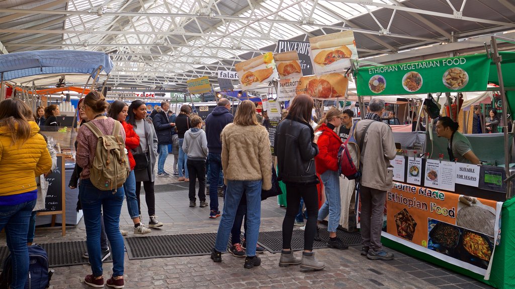 Greenwich Market showing markets as well as a small group of people