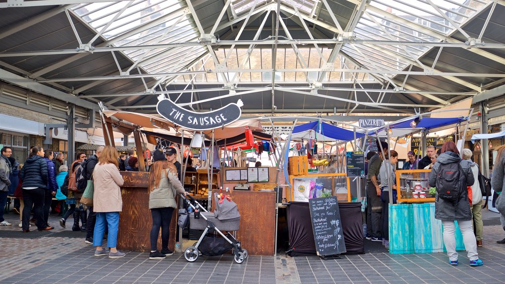 Greenwich Market showing markets as well as a small group of people