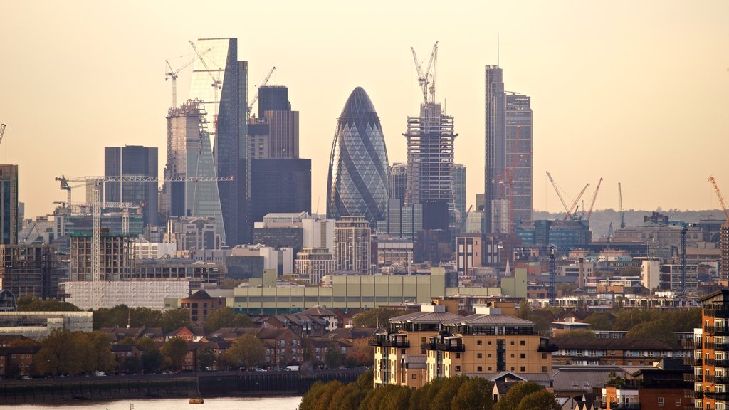 Greenwich Park showing a high rise building, landscape views and a sunset