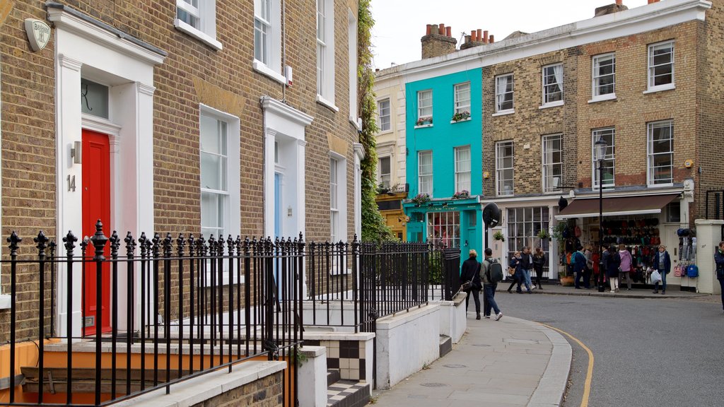 Portobello Road Market showing a house and street scenes as well as a small group of people