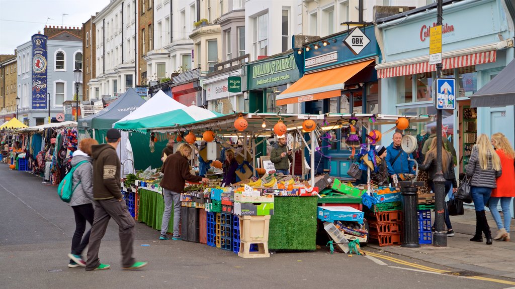 Portobello Road Market showing street scenes and markets as well as a small group of people